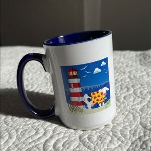 Navy-Trim Ceramic Mug with Lighthouse & Cow Illustration